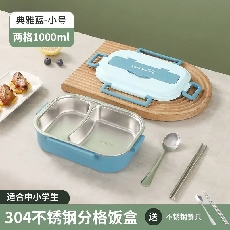 Light blue two-compartment stainless steel lunchbox with a matching lid and handles, featuring the brand name ’sucin’ on its interior.