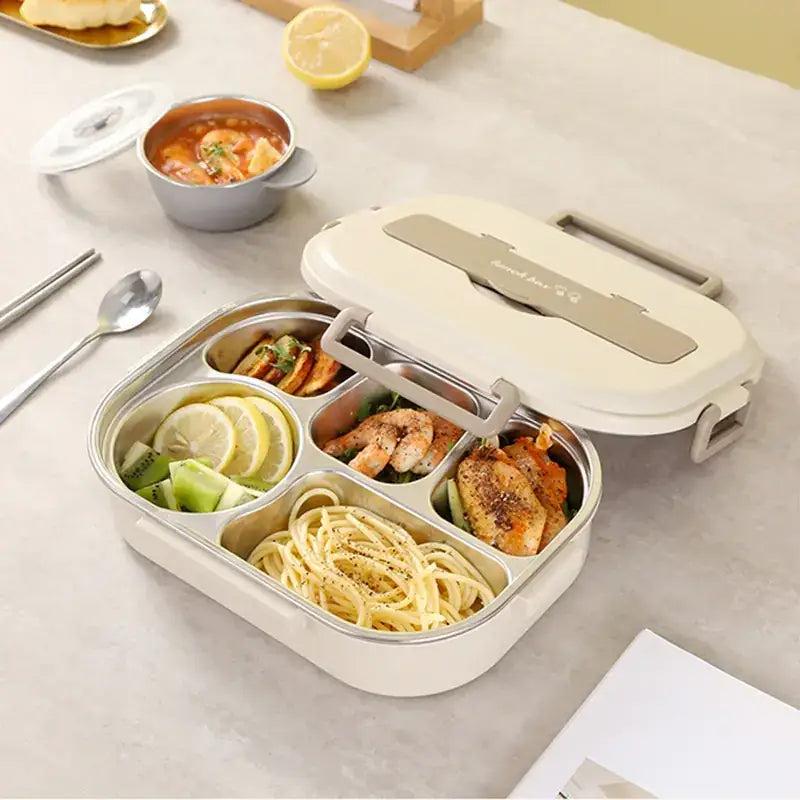 Cream-colored, multi-compartment stainless steel lunchbox with a matching lid and gray handle accents.