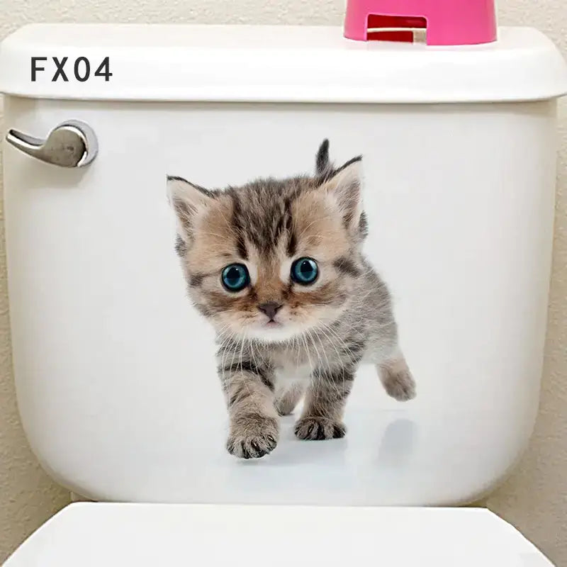 A charming brown tabby kitten decal with striking blue eyes adorns the white toilet tank.