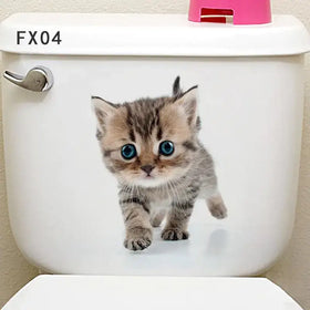 A charming brown tabby kitten decal with striking blue eyes adorns the white toilet tank.