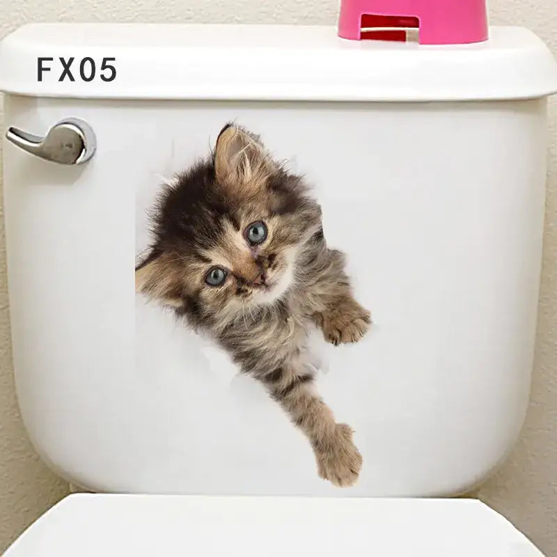 Adorable brown and black tabby kitten decal with striking blue eyes, applied to a white toilet tank.