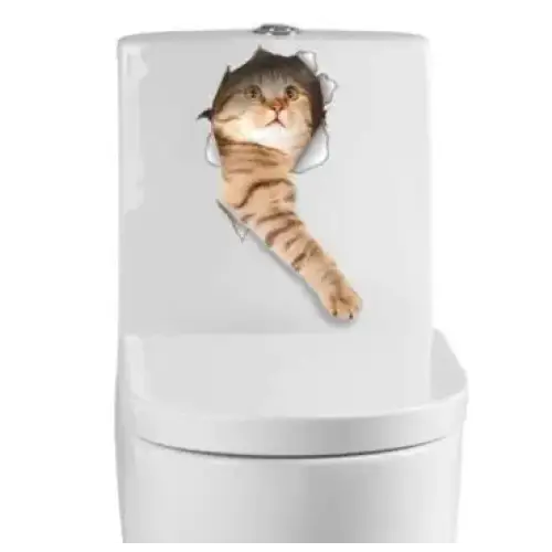A tabby cat with brown and black stripes peeks through a hole in the white toilet tank, its paw extended as if reaching out.