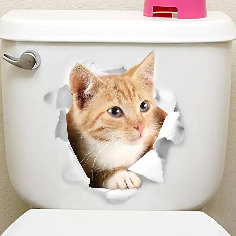 A charming orange tabby kitten with white fur peeking through a 3d-effect torn-paper decal on a white toilet tank.