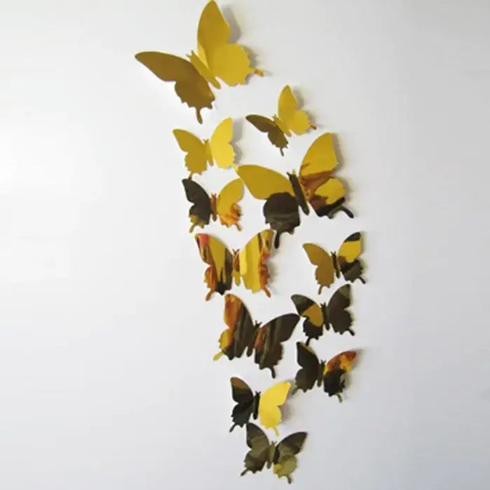 A set of golden and mirrored butterfly wall decals arranged in a flowing pattern.