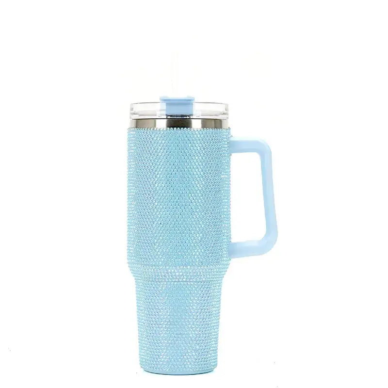 A light blue, diamond-encrusted travel mug with a sleek handle and clear lid.