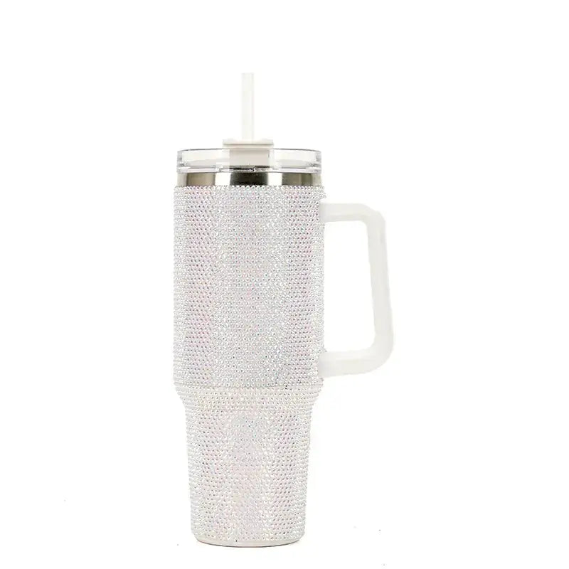 A sparkling white rhinestone-encrusted insulated tumbler with a handle and straw.