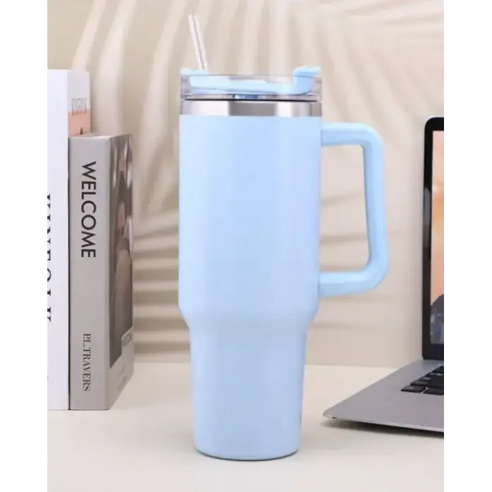 Light blue insulated tumbler with a matching handle and clear lid featuring a straw.
