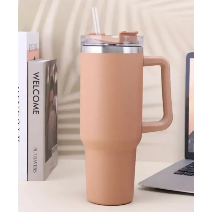 Beige insulated travel mug with a handle, clear lid and straw.