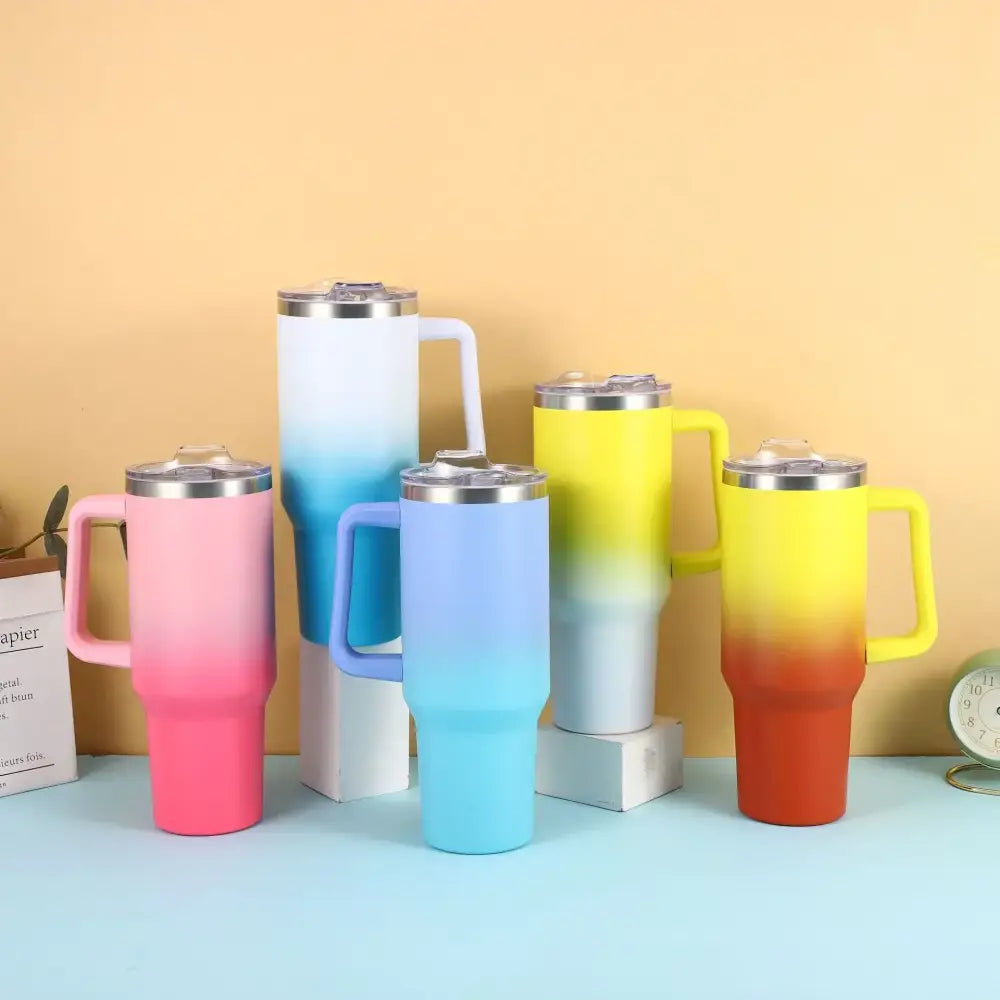 Gradient-colored stainless steel travel mugs with matching handles and lids.
