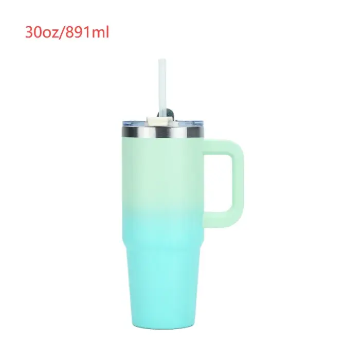 A 30oz insulated tumbler with a gradient mint to teal finish, featuring a stainless steel rim and handle.