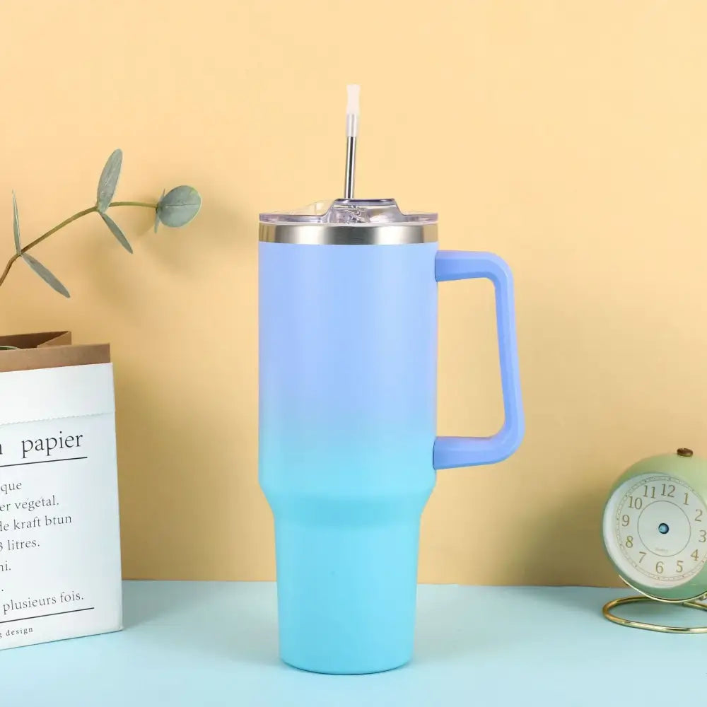 Light blue gradient stainless steel tumbler with a handle and straw.