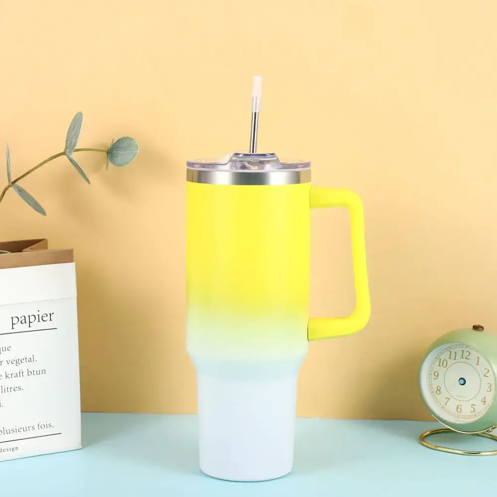 Bright yellow-to-white gradient insulated tumbler with a matching handle and clear lid featuring a straw.
