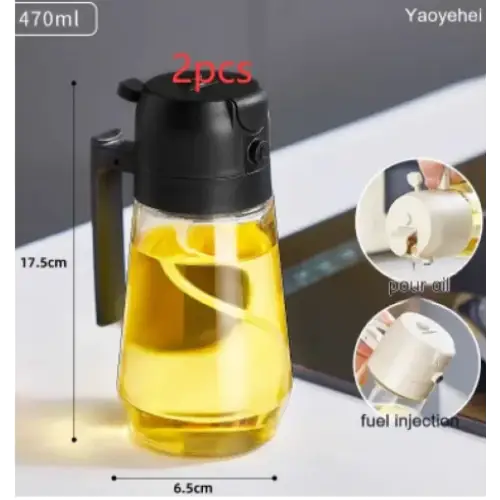Clear glass oil dispenser with black plastic lid and handle, filled with golden-yellow pear oil.