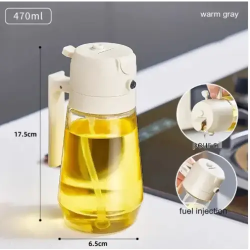 A sleek, 470ml warm gray oil dispenser with a transparent glass body and white plastic handle and pump mechanism.