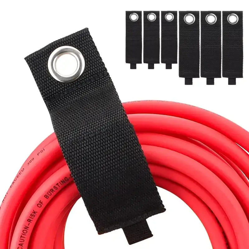 Black fabric strap with a silver metal grommet, designed to secure and organize red high-pressure hose.