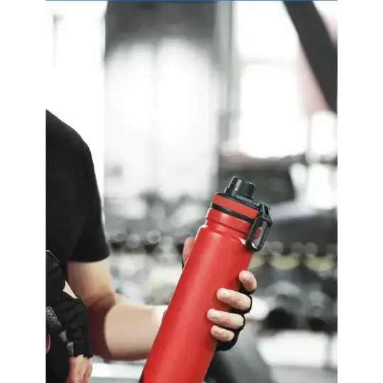 Red insulated water bottle with black screw-on lid and carrying loop.