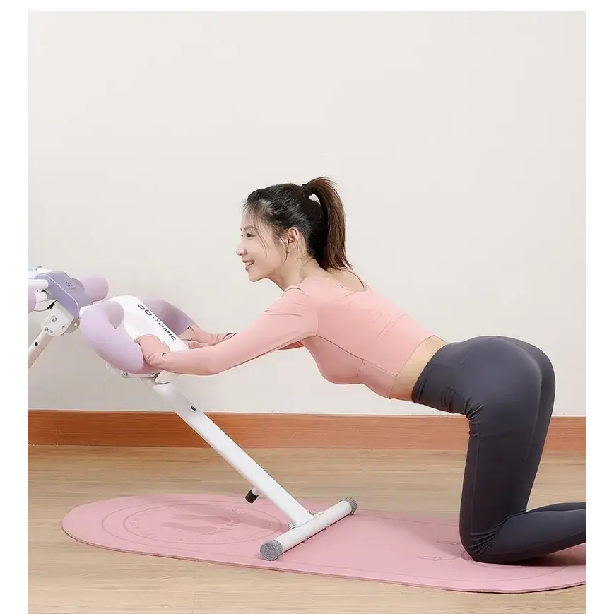 Pink and white abdominal exercise machine with padded handles.