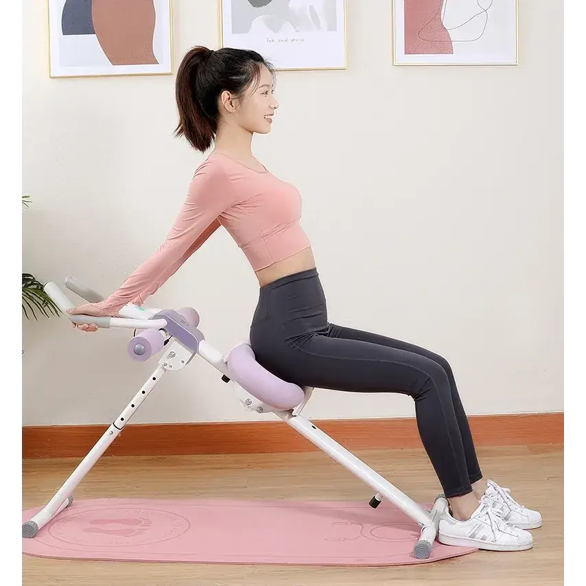 Pink and white adjustable ab roller machine with padded seat and handlebars