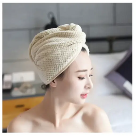 Beige woven microfiber towel wrapped around a woman’s head.