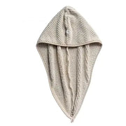Beige textured towel hood with button closure.