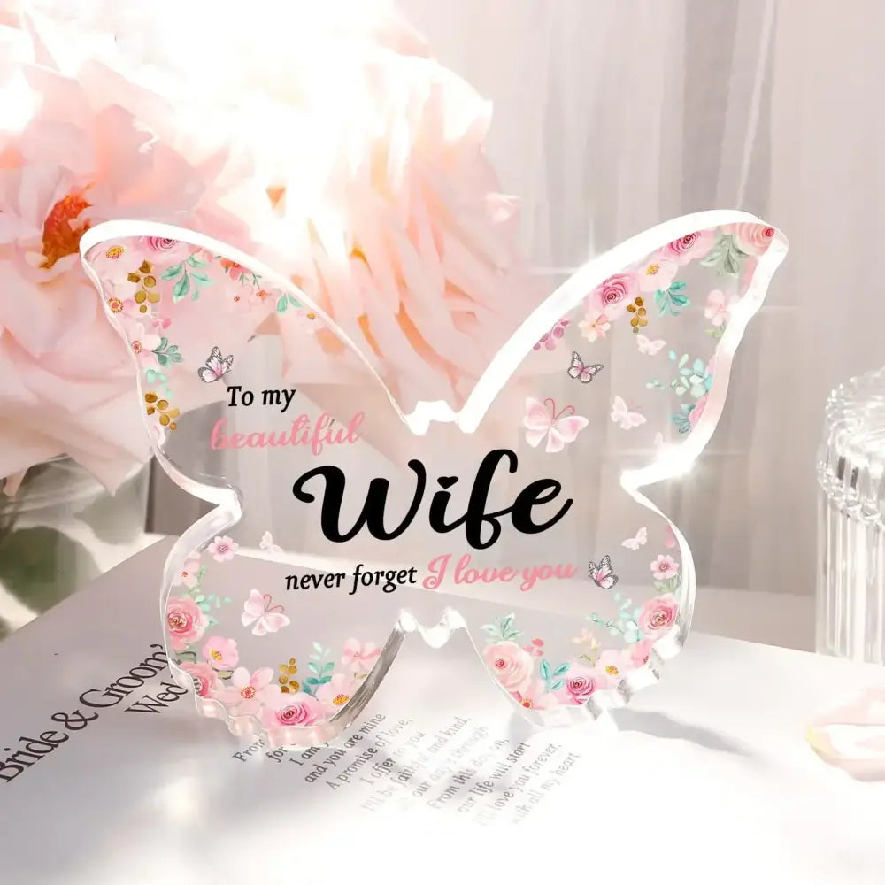 Clear acrylic butterfly-shaped keepsake with delicate pink and green floral patterns, featuring the inscription ’to my beautiful wife never forget i love you’ in black cursive script.