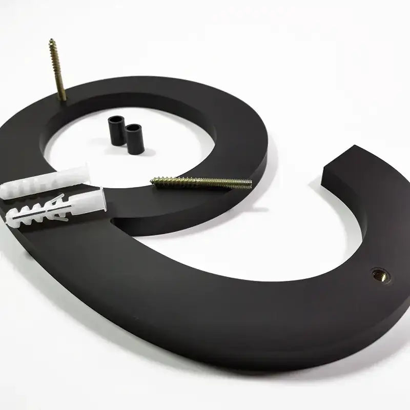 Black matte-finished metal house number ’3’ with mounting hardware.