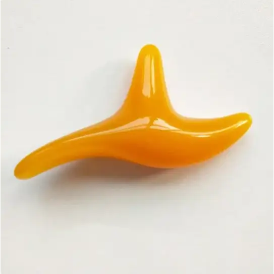 Vibrant orange, glossy plastic gua sha tool with a smooth, ergonomic design.