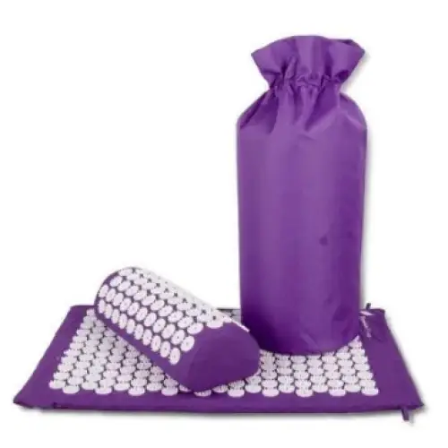Purple acupressure mat and cylindrical pillow with white, rounded beads arranged in a grid pattern.