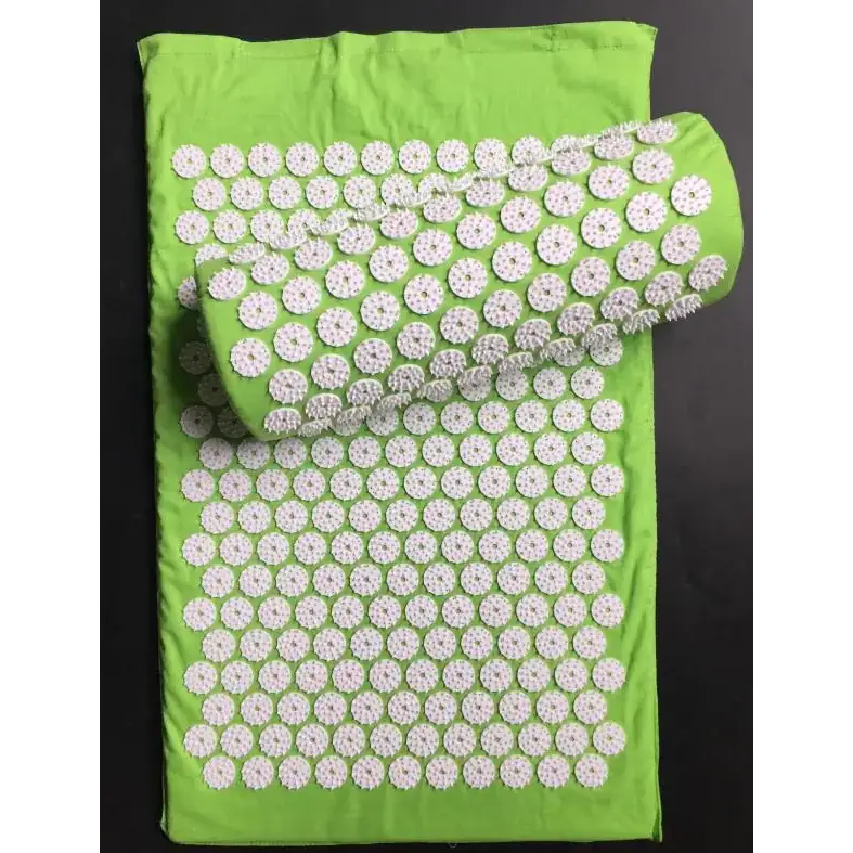 Bright green acupressure mat with white, circular, textured pins arranged in a grid pattern.