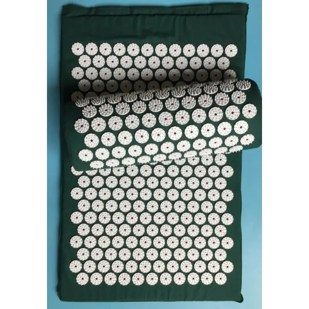 Dark green fabric mat featuring a grid of white, circular acupuncture point mats with raised, spiky protrusions.