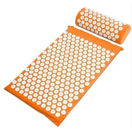 Orange acupressure mat and pillow set with white circular needles.