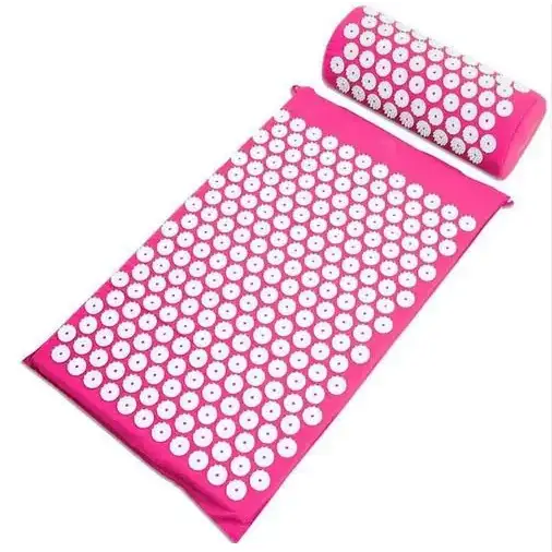 Pink acupressure mat and pillow set with white circular needles.