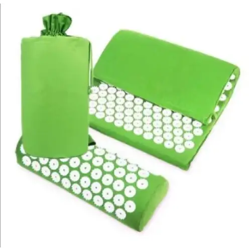 Green acupressure mat set with white circular needles embedded in a soft fabric surface.