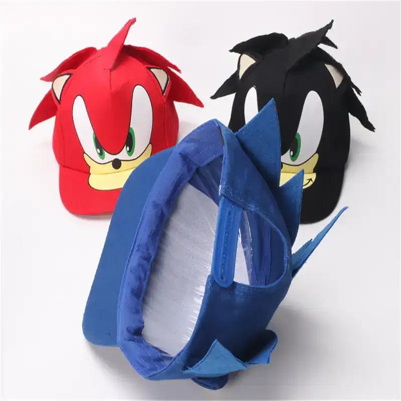 Red, black, and blue sonic the hedgehog character hats made of fabric with embroidered facial features.