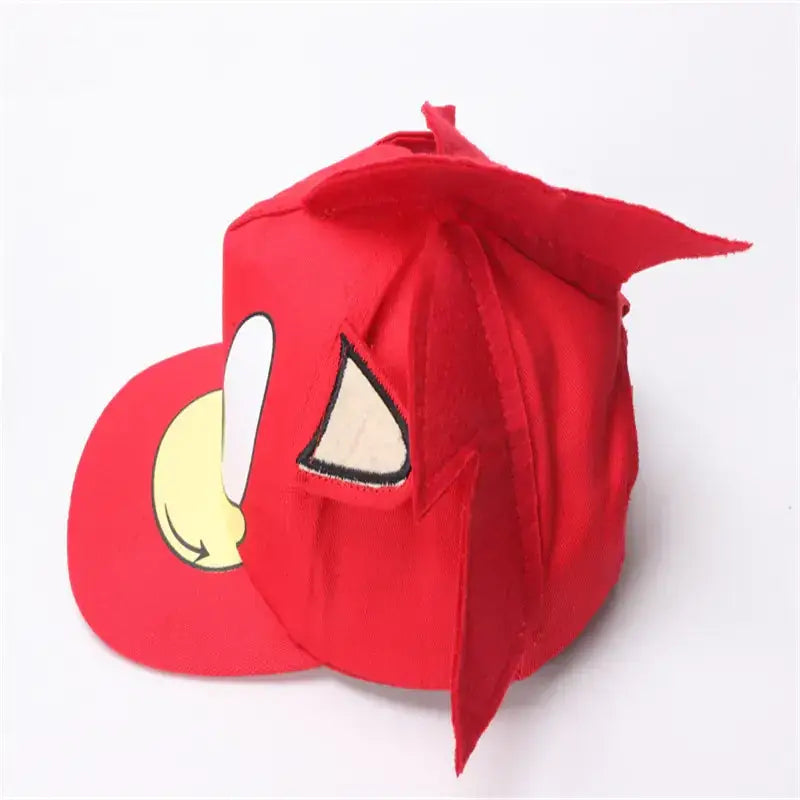 Red fabric cap featuring a cartoon bird face with yellow beak and white eye patch, accented by stitched black outlines.