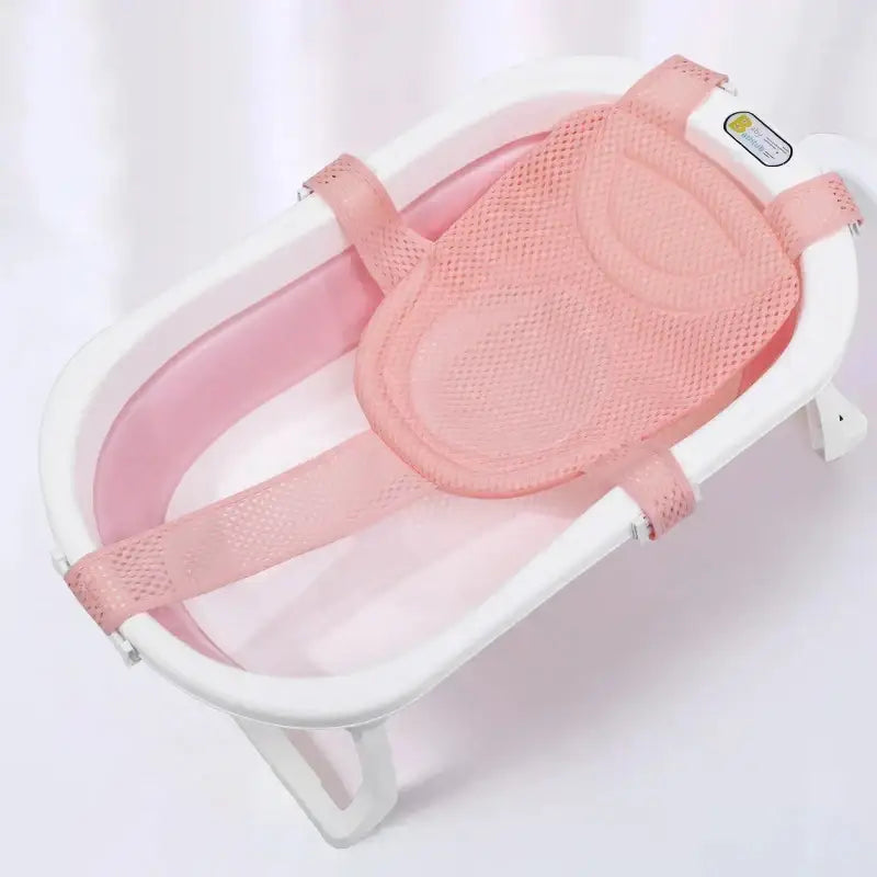 Pink mesh baby bath safety seat with adjustable straps and white plastic frame.