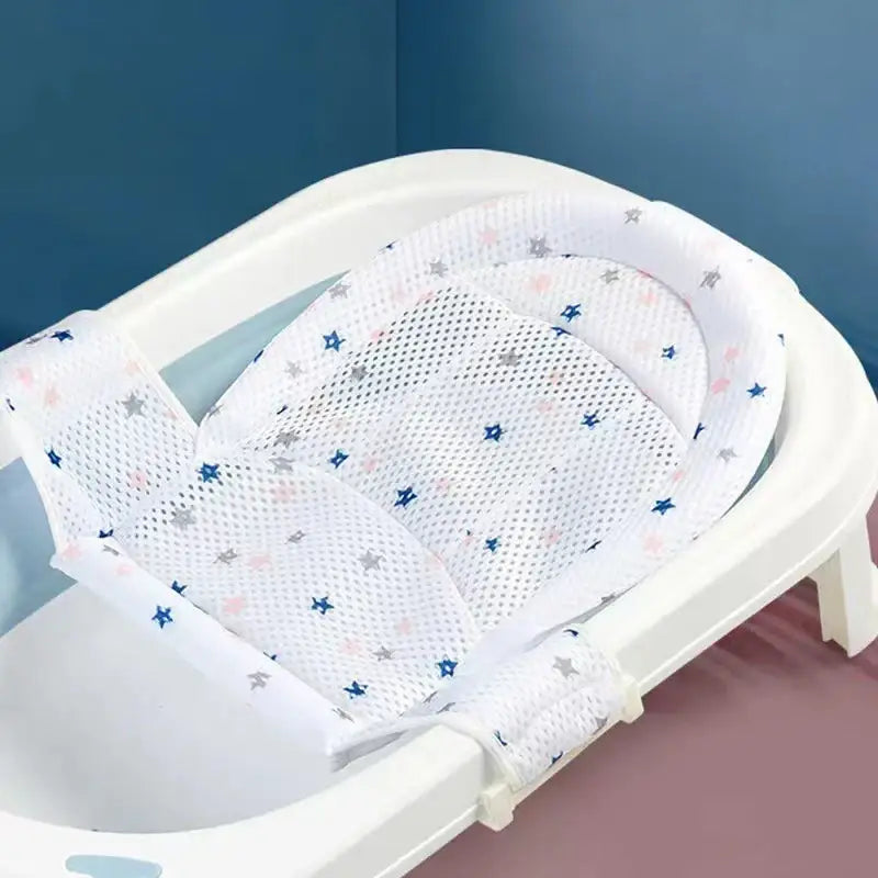 White mesh bath seat with star patterns in blue, pink, and gray.