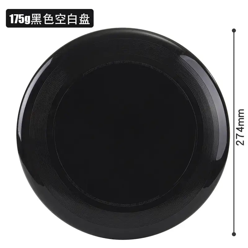 A sleek, glossy black plastic frisbee with concentric ridges and a smooth, rounded edge.