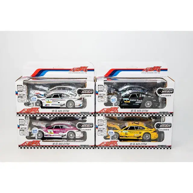 Four die-cast bmw m3 dtm race cars in white, black, pink and yellow livery.