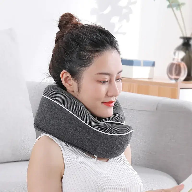 Gray fabric neck massager with white stitching along the edges.