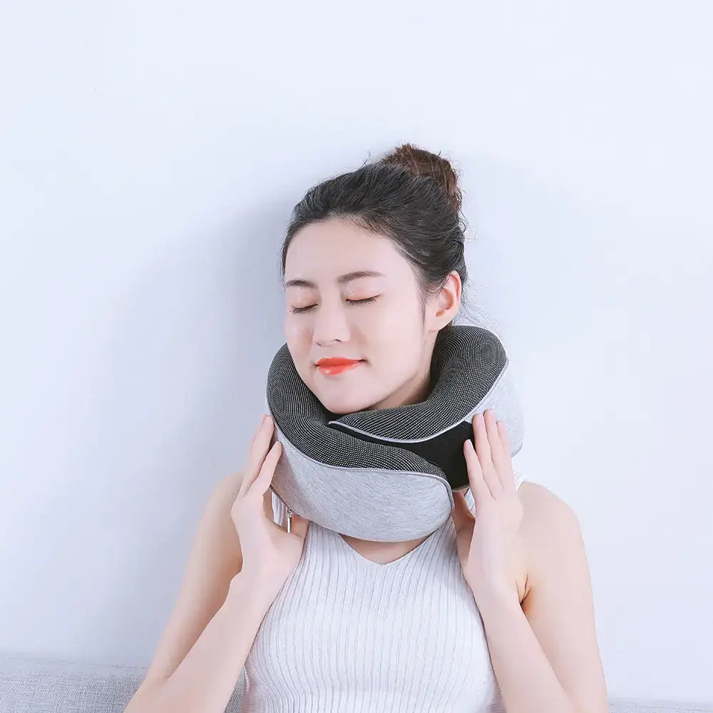 Gray and black ergonomic neck pillow with soft fabric exterior.