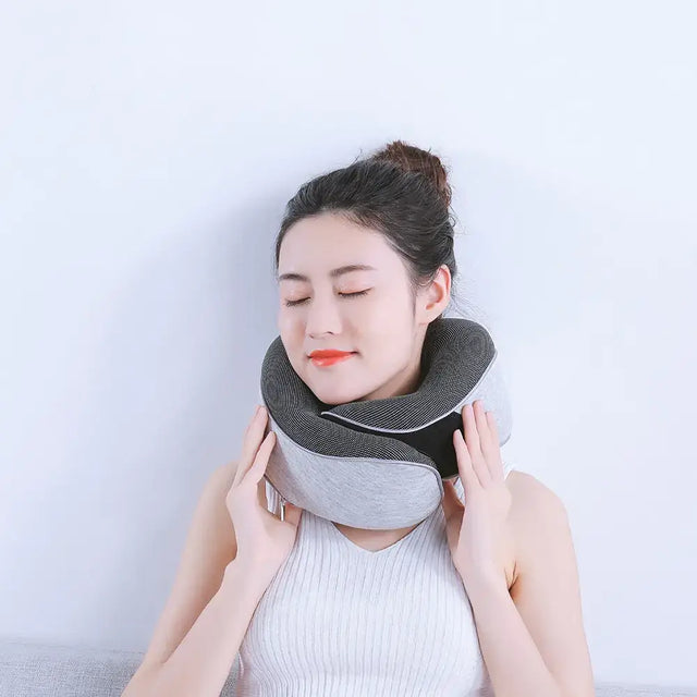 Gray and black ergonomic neck pillow with soft fabric exterior.
