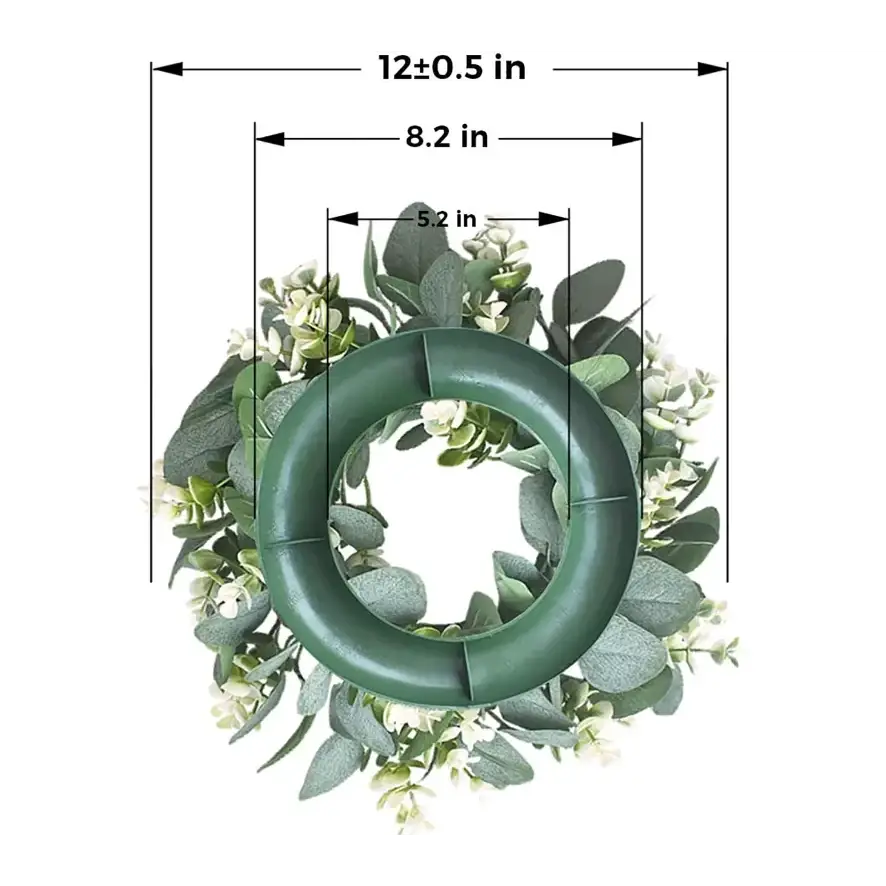 Green artificial eucalyptus wreath with white flowers.