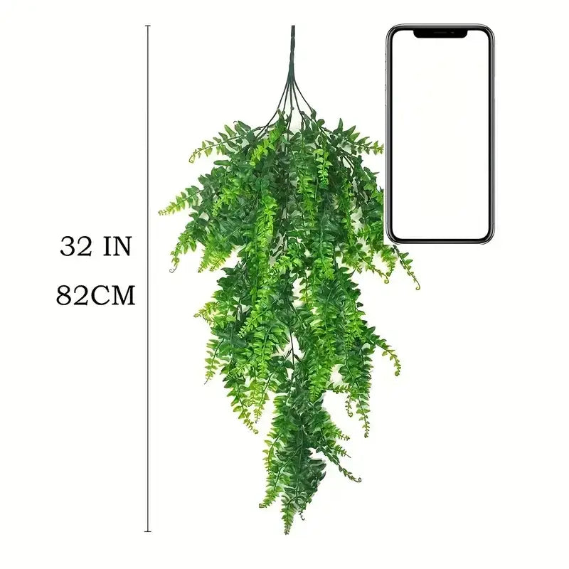 Green artificial fern hanging plant, 32 inches long.