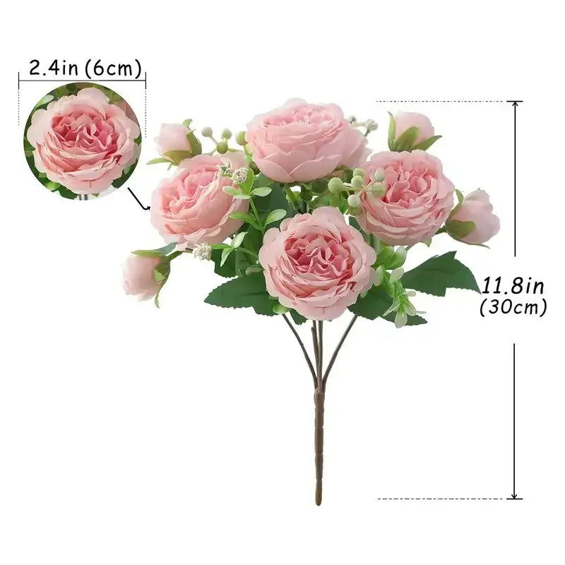A delicate arrangement of artificial pink roses with green leaves and small white buds, crafted from synthetic fabric.