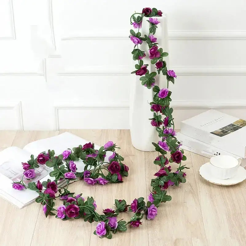 Purple and deep magenta artificial rose garland with green leaves, crafted from synthetic fabric.
