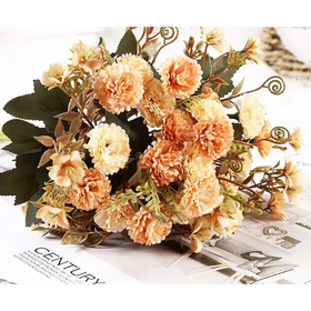A delicate bouquet of peach and cream-colored artificial flowers with green leaves and curly stems.