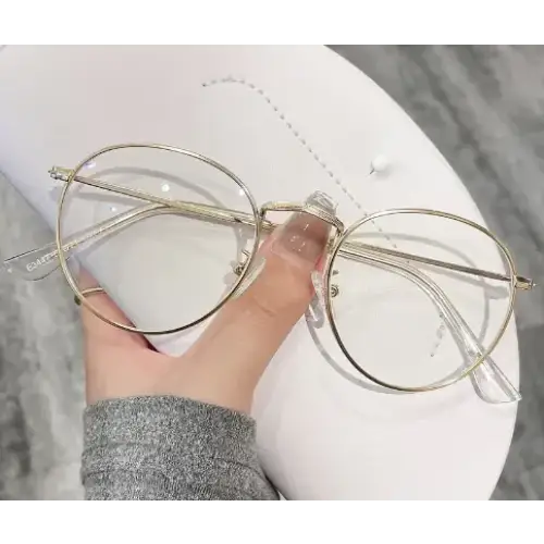 Gold-rimmed round glasses with clear lenses and transparent temple arms