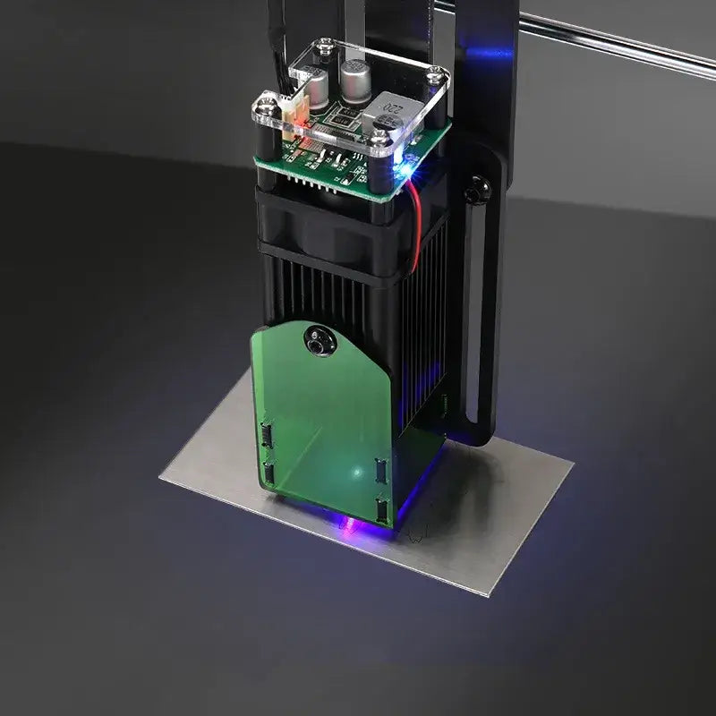 Green and black laser engraving machine with a transparent acrylic top housing electronic components.