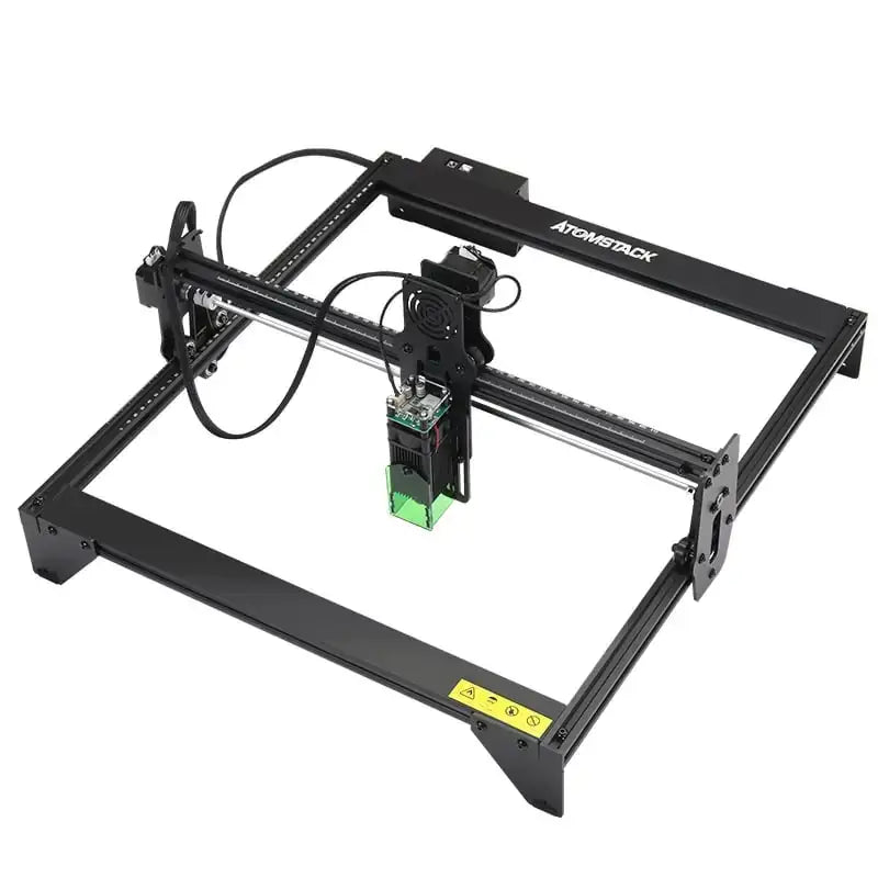 Black atomstack laser engraving machine with a green-lit laser head and metal frame.
